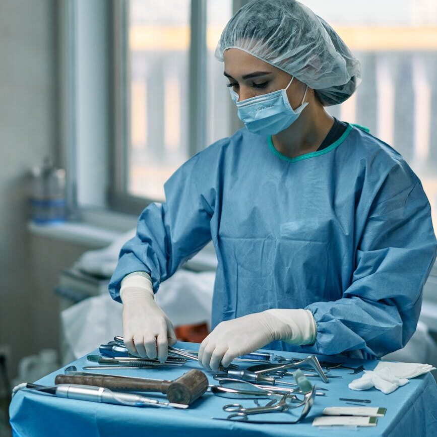 a woman arranging medical tools in an operating room